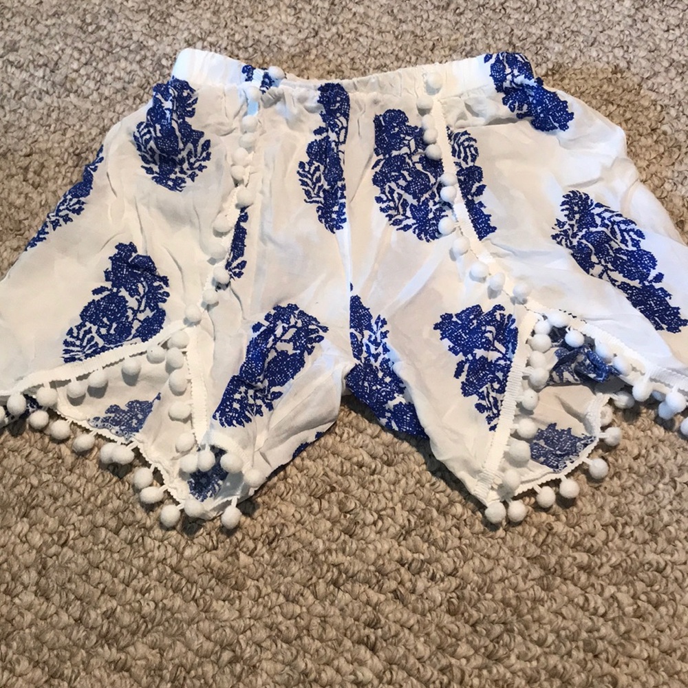 flowy shorts with pom poms at end